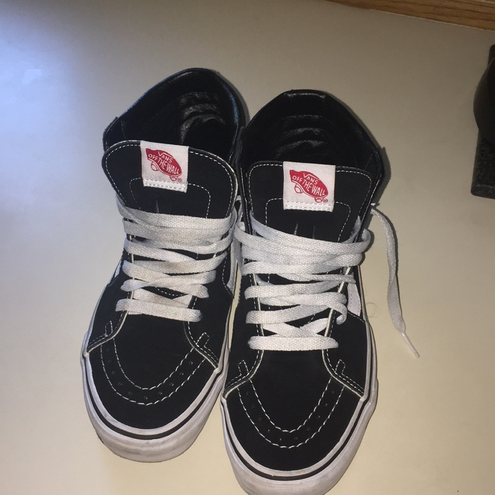Black and white high top vans